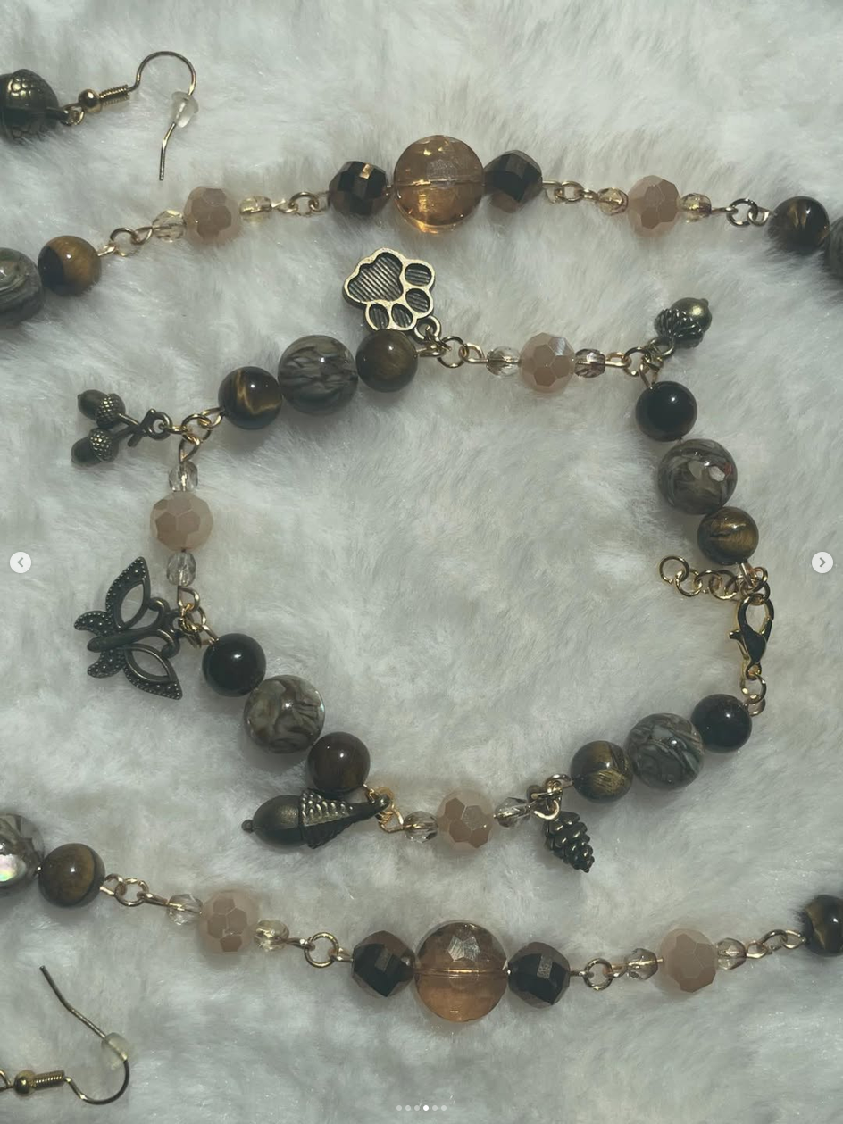 Close-up of a handmade beaded bracelet with woodland charms